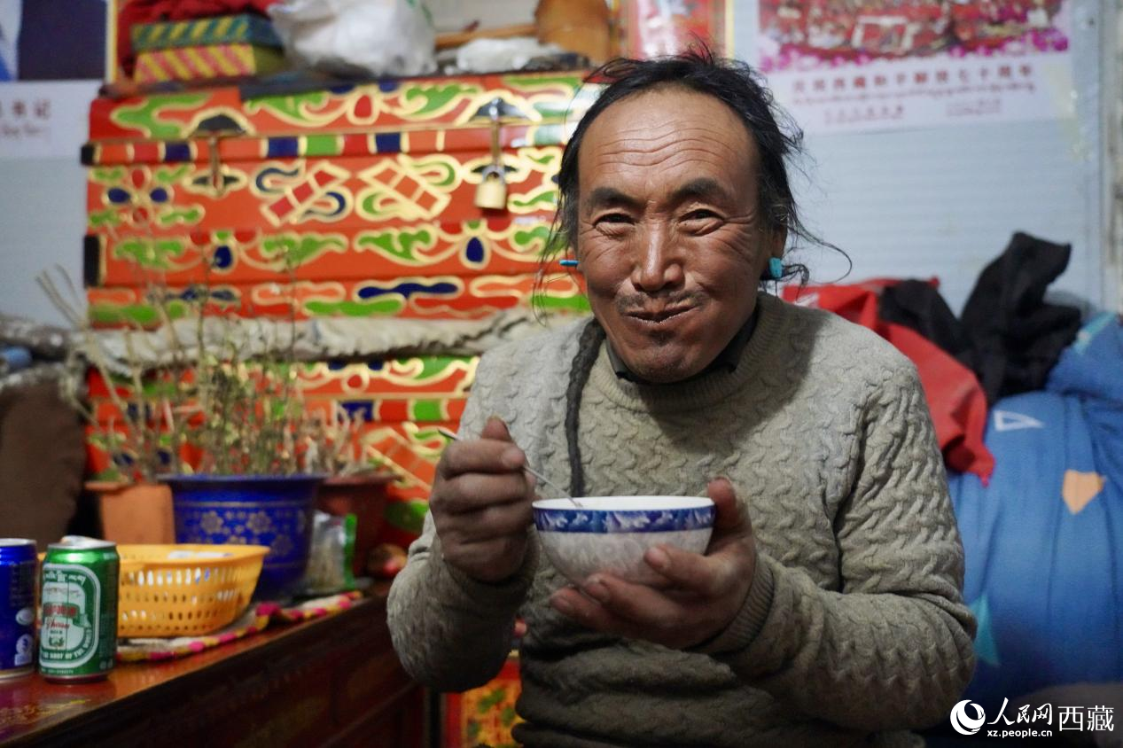 熱木青村安置點，氤氳著酥油茶香的板房里，群眾吃著年夜飯。